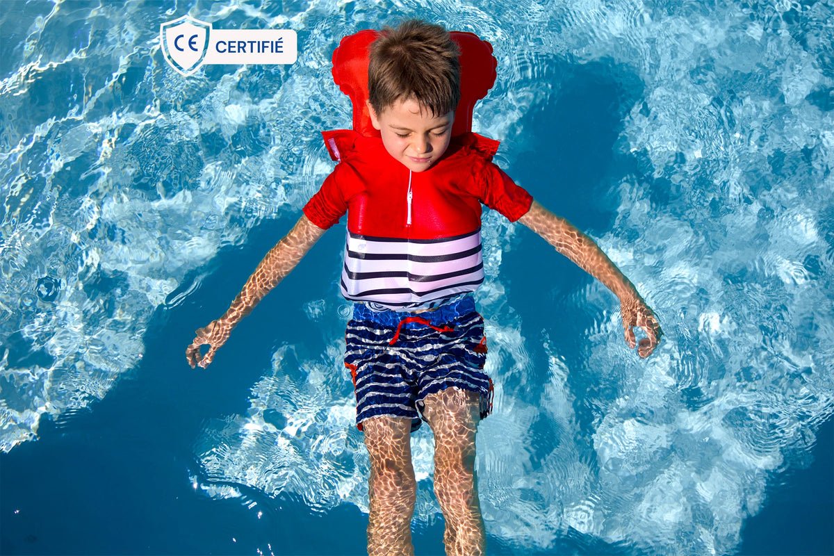 Little boy in water, wearing a Floatee anti-drowning T-shirt which has been triggered (lifejacket inflated automatically)