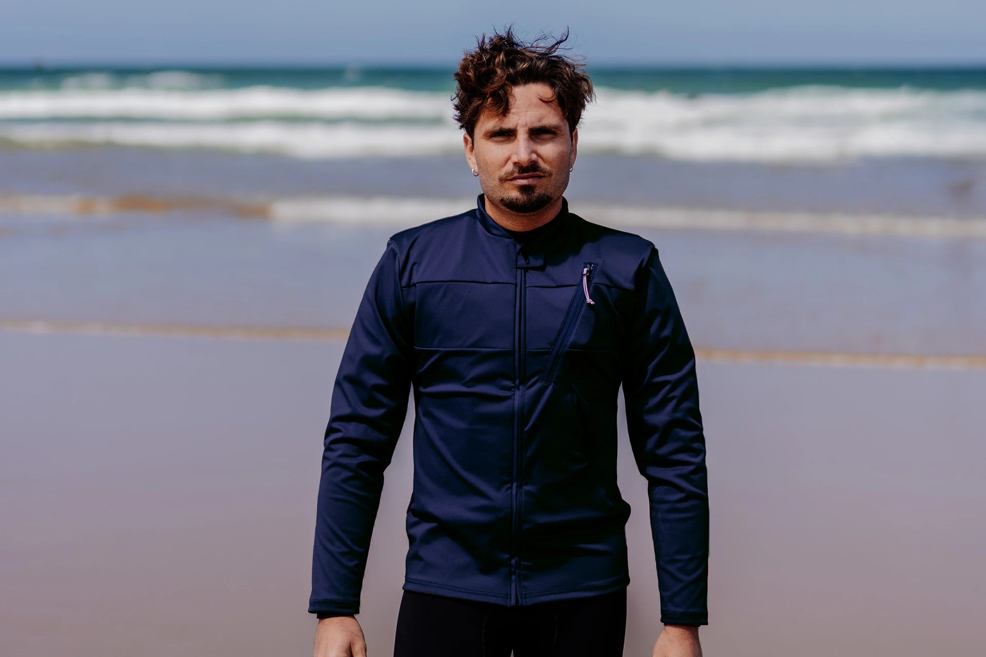 Man on a beach wearing a Floatee anti-drowning T-shirt blue with long sleeves